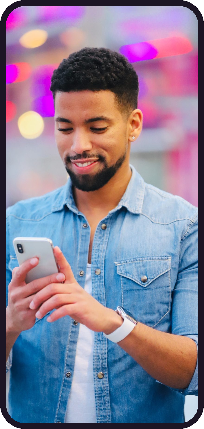 A Kalkidan member smiling at his phone, framed in a phone